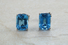 Load image into Gallery viewer, Natural Emerald cut blue Topaz stud earrings set in solid 9ct white gold
