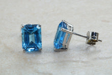 Load image into Gallery viewer, Natural Emerald cut blue Topaz stud earrings set in solid 9ct white gold