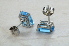Load image into Gallery viewer, Natural Emerald cut blue Topaz stud earrings set in solid 9ct white gold