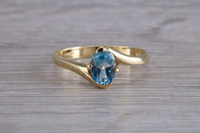 Load image into Gallery viewer, One carat Oval cut Blue Topaz set 18ct Yellow Gold Ring