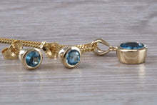 Load image into Gallery viewer, Round cut Blue Topaz Matching Earrings and Necklace set in Yellow Gold