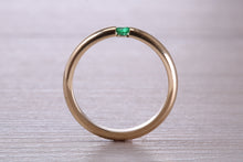 Load image into Gallery viewer, Tension set Emerald in Chunky Yellow Gold Band, British Hallmarked