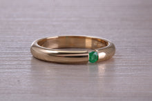 Load image into Gallery viewer, Tension set Emerald in Chunky Yellow Gold Band, British Hallmarked