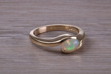 Load image into Gallery viewer, Oval cut Natural Opal set in Chunky Crossover Yellow Gold Ring