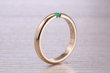 Load image into Gallery viewer, Tension set Emerald in Chunky Yellow Gold Band, British Hallmarked