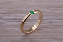 Load image into Gallery viewer, Tension set Emerald in Chunky Yellow Gold Band, British Hallmarked