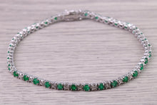 Load image into Gallery viewer, Four and Half carats Natural Emeralds and Diamonds set White Gold Tennis Bracelet, British Hallmarked
