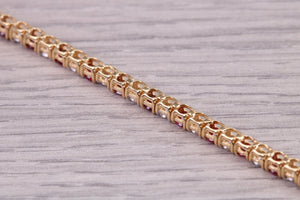 Four carats Natural Rubies and Diamonds set Solid Yellow Gold Tennis Bracelet, British Hallmarked