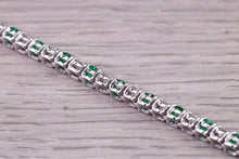 Load image into Gallery viewer, Four and Half carats Natural Emeralds and Diamonds set White Gold Tennis Bracelet, British Hallmarked