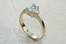 Load image into Gallery viewer, This combination of Diamond and blue Topaz trilogy ring is sure to be the gift of choice. solid 9ct yellow gold. Just the perfect gift