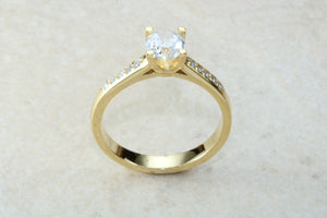 One carat Forever One grade Charled and Colvard Moissanite complemented with natural diamond on the sides of this beautiful 18ct gold ring