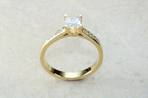 One carat Forever One grade Charled and Colvard Moissanite complemented with natural diamond on the sides of this beautiful 18ct gold ring