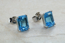 Load image into Gallery viewer, Natural Emerald cut blue Topaz stud earrings set in solid 9ct white gold