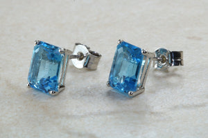 Natural Emerald cut blue Topaz stud earrings set in solid 9ct white gold