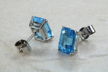 Load image into Gallery viewer, Natural Emerald cut blue Topaz stud earrings set in solid 9ct white gold