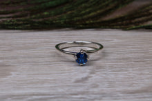Load image into Gallery viewer, Silver solitaire ring with four claw twist setting of beautiful round royal blue sapphire C Z