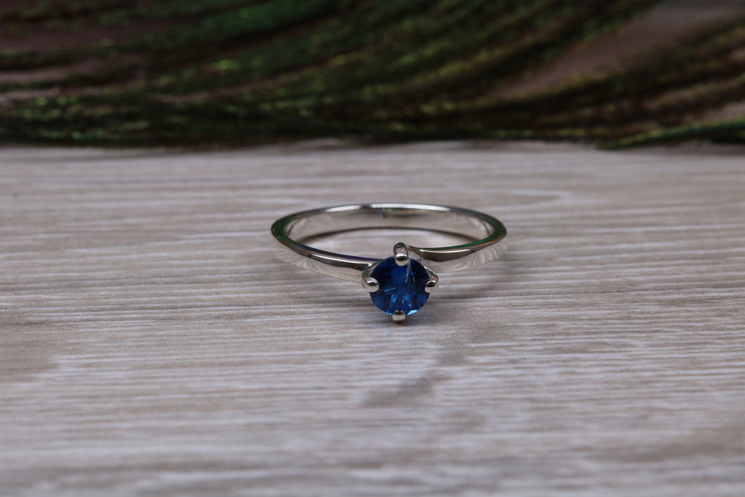 Silver solitaire ring with four claw twist setting of beautiful round royal blue sapphire C Z