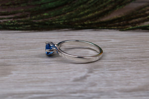 Silver solitaire ring with four claw twist setting of beautiful round royal blue sapphire C Z