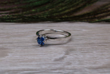 Load image into Gallery viewer, Silver solitaire ring with four claw twist setting of beautiful round royal blue sapphire C Z