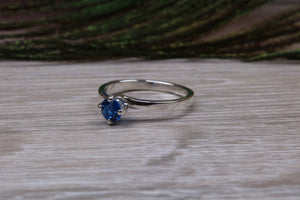 Silver solitaire ring with four claw twist setting of beautiful round royal blue sapphire C Z