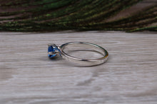 Load image into Gallery viewer, Silver solitaire ring with four claw twist setting of beautiful round royal blue sapphire C Z