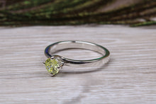 Load image into Gallery viewer, Silver solitaire twist style ring set with beautiful round Peridot C Z,ideal as promise, engagement or even dress ring.
