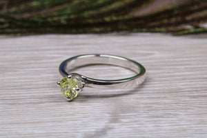 Silver solitaire twist style ring set with beautiful round Peridot C Z,ideal as promise, engagement or even dress ring.