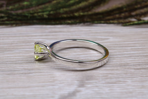 Silver solitaire twist style ring set with beautiful round Peridot C Z,ideal as promise, engagement or even dress ring.
