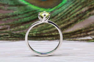 Silver solitaire twist style ring set with beautiful round Peridot C Z,ideal as promise, engagement or even dress ring.
