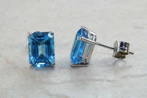 Natural Emerald cut blue Topaz stud earrings set in solid 9ct white gold