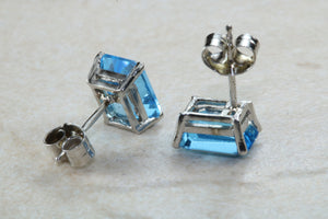Natural Emerald cut blue Topaz stud earrings set in solid 9ct white gold
