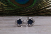 Load image into Gallery viewer, One carat each Blue Sapphire and Diamond Halo set Earrings