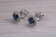 Load image into Gallery viewer, One carat each Blue Sapphire and Diamond Halo set Earrings
