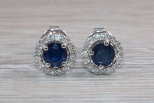 Load image into Gallery viewer, One carat each Blue Sapphire and Diamond Halo set Earrings