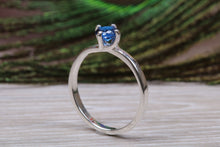 Load image into Gallery viewer, Silver solitaire ring with four claw twist setting of beautiful round royal blue sapphire C Z