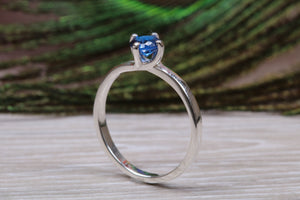 Silver solitaire ring with four claw twist setting of beautiful round royal blue sapphire C Z