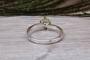 Silver solitaire twist style ring set with beautiful round Peridot C Z,ideal as promise, engagement or even dress ring.