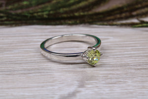 Silver solitaire twist style ring set with beautiful round Peridot C Z,ideal as promise, engagement or even dress ring.