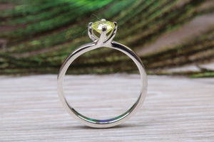 Silver solitaire twist style ring set with beautiful round Peridot C Z,ideal as promise, engagement or even dress ring.