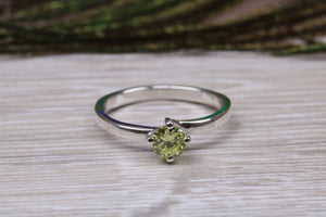 Silver solitaire twist style ring set with beautiful round Peridot C Z,ideal as promise, engagement or even dress ring.