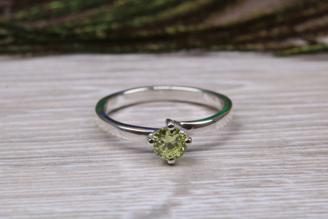 Silver solitaire twist style ring set with beautiful round Peridot C Z,ideal as promise, engagement or even dress ring.