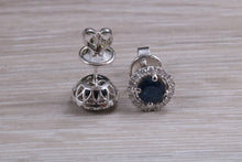 Load image into Gallery viewer, One carat each Blue Sapphire and Diamond Halo set Earrings