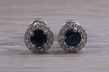 Load image into Gallery viewer, One carat each Blue Sapphire and Diamond Halo set Earrings