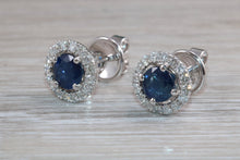 Load image into Gallery viewer, One carat each Blue Sapphire and Diamond Halo set Earrings