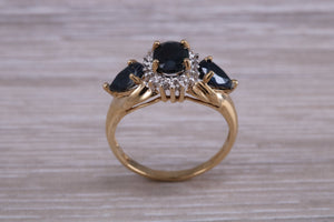 Beautiful Blue Sapphire and Diamond cluster dress ring, dark blue Sapphire with top white grade diamonds set in 9ct Yellow gold