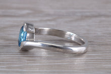 Load image into Gallery viewer, Oval cut Blue Topaz set Crossover Ring