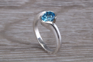 Oval cut Blue Topaz set Crossover Ring