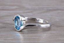 Load image into Gallery viewer, Oval cut Blue Topaz set Crossover Ring
