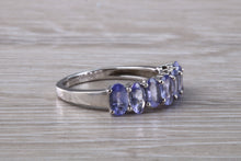 Load image into Gallery viewer, 7 stone natural Tanzanite eternity ring, oval cut Tanzanite set in 9ct white gold, one and half carats Tanzanite
