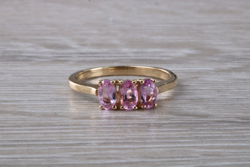 Oval Pink Topaz set Yellow Gold Trilogy Ring